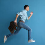 Running,Man,With,Briefcase,On,Color,Background